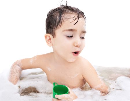 Boy washing in the bathroom and plays with toy