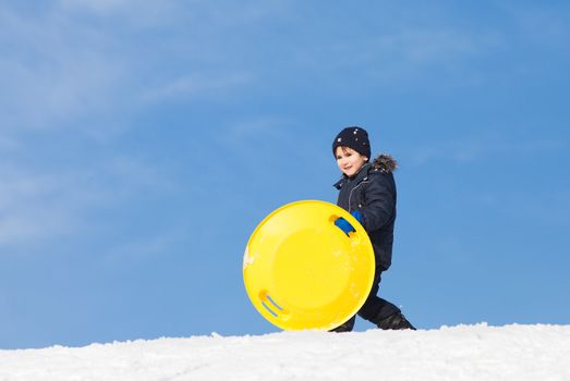 Boy with sleigh. Sledding at winter time