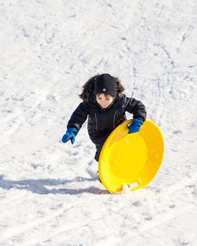 Boy on sleigh. Sledding at winter time