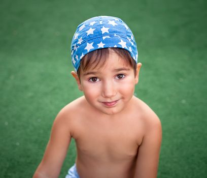 cute young boy wearing bandana outside portrait