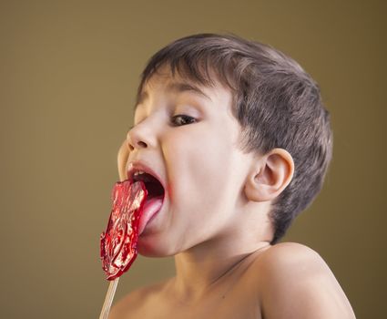 Close Up of Young Boy Eating A Lollipop