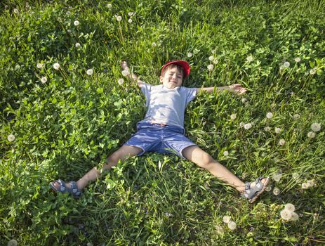 4 years old boy lying on the grass