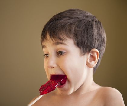 Close Up of Young Boy Eating A Lollipop