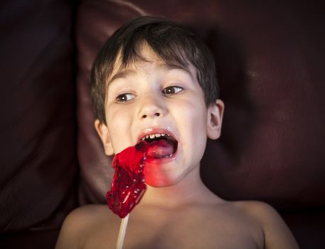 Close Up of Young Boy Eating A Lollipop