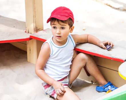 Portrait of a 3-4 years boy playing on the playground