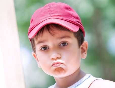 Portrait of a 3-4 years boy playing on the playground