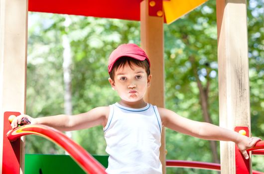 Portrait of a  3-4 years boy playing on the playground