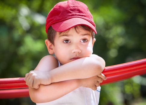 Portrait of a 3-4 years boy playing on the playground