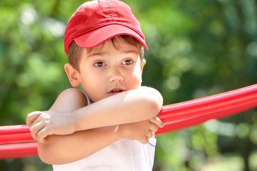 Portrait of a 3-4 years boy playing on the playground