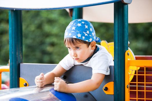 Portrait of a  3-4 years boy playing on the playground