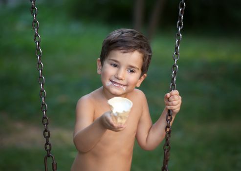 Cute little boy 3-4 years eats ice cream 