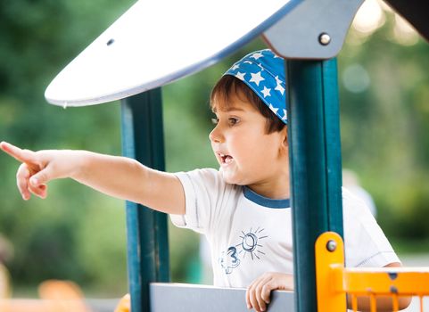 Portrait of a  3-4 years boy playing on the playground