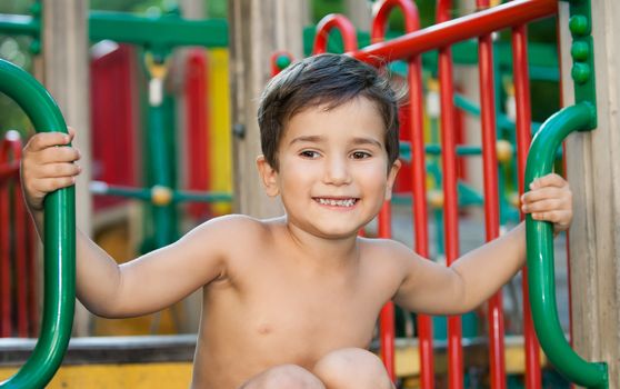 Full of emotion 3-4 years boy playing on the playground