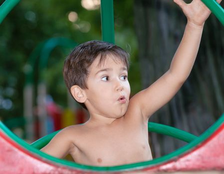 Full of emotion 3-4 years boy playing on the playground