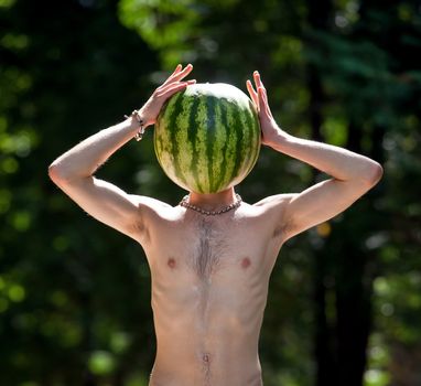 Mr.Watermelon. Humorous photo of a  boy with a watermelon instead of head