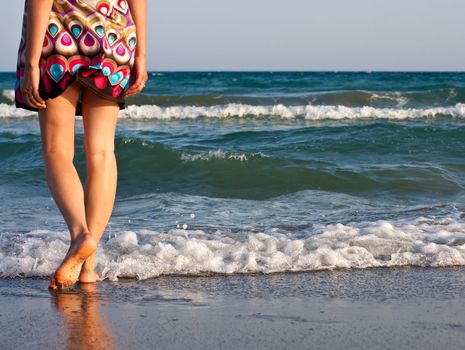 Young woman alone looking out over the sea