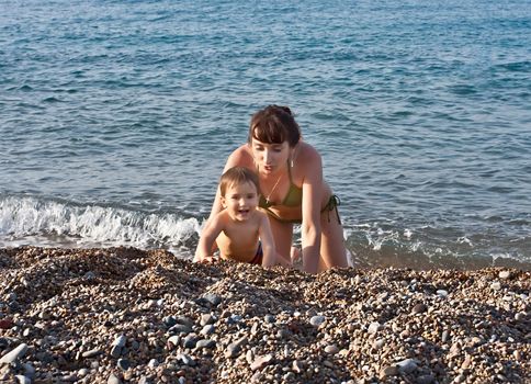 Mother and child playing on the beach