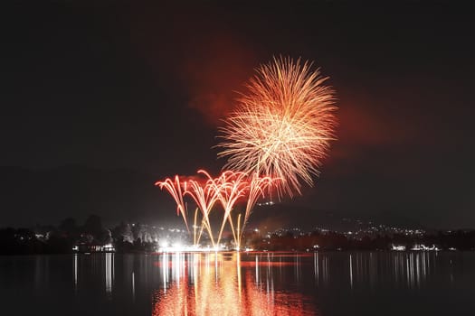 Fireworks on Monate Lake in a summer night, Varese - Italy