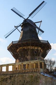 Old wood and stone historical wind mill in Potsdam, Germany