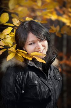 Happy young woman in autumn forest