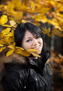 Happy young woman in autumn forest
