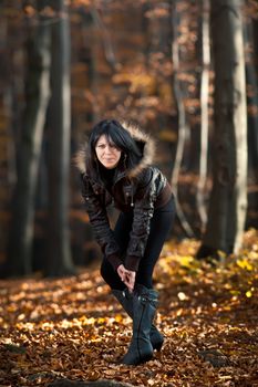 Young woman walking in the autumn forest