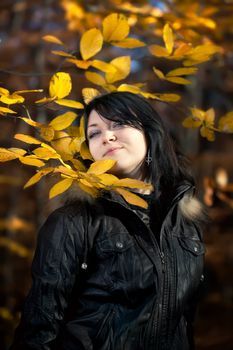 Happy young woman in autumn forest