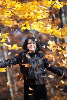 Happy young woman in autumn forest
