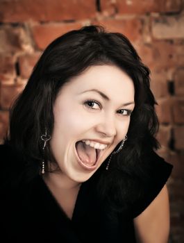 Surprised young girl on brick wall background