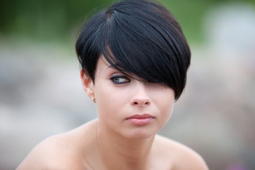 Portrait of a young attractive woman with tattoo on blurred background