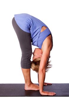 Beautiful healthy woman doing Standing Forward Fold Uttanasana hamstring stretch yoga, on white.