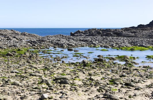 rocky coast of northern France against the beautiful blue sky