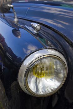 Fragment of retro car - headlight close up