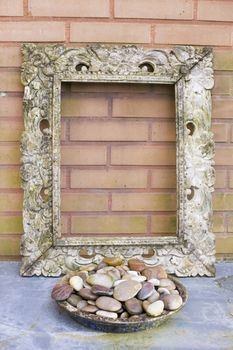 Wooden picture frame against  a brick background