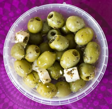 feta cheese and olives with herbs in olive oil