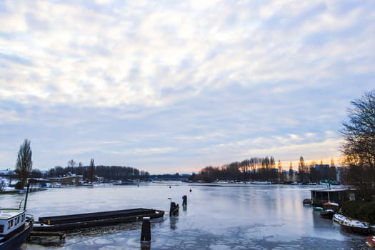 Frozen Amstel river in wintertime in Amsterdam, the Netherlands