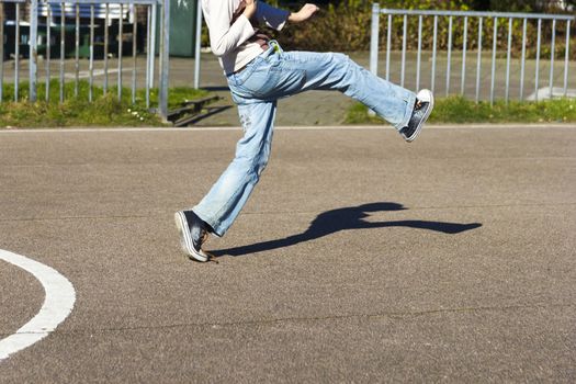 The boy is hitting the ball on the playground