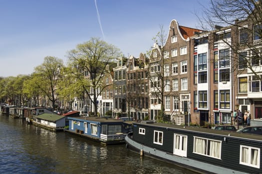View on the houseboats with cruiseboat in Amsterdam the Netherlands