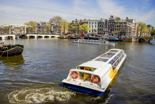 View on Amsterdam and Amstel rive with cruise boats , the Netherlands