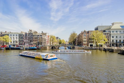 View on the houseboats with cruiseboat in Amsterdam the Netherlands