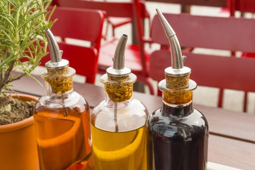balsamic vinegar bottles and condiments on the table in an open cafe
