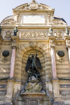 Fountain Saint-Michel at Place Saint-Michel in Paris, France. It was constructed in 1858-1860 during French Second Empire by architect Gabriel Davioud. Archangel Michael and devil by Francisque Duret.