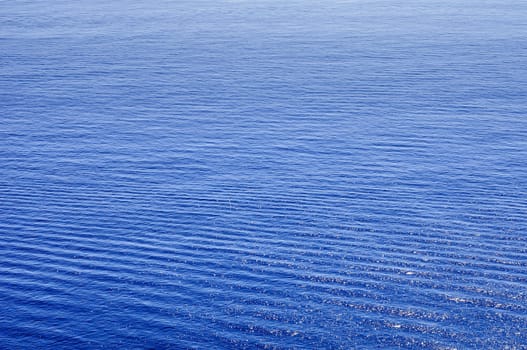 Sea landscape under the sun with waves and reflections