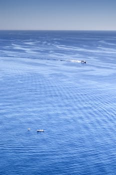 Sea landscape under the sun with waves, reflections and  ships and boats