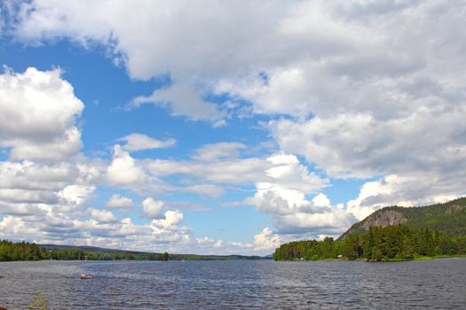 View on Norwegian fjord and mountain range at sunny day