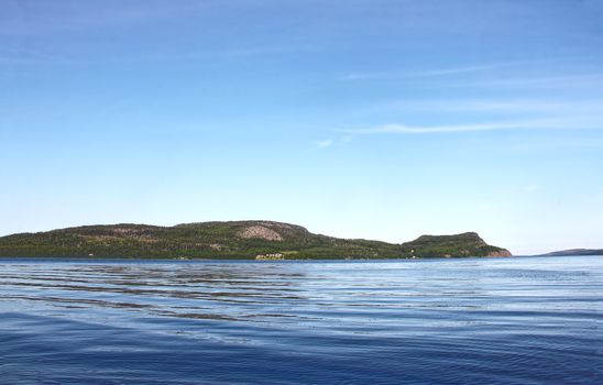 View on Norwegian fjord and mountain range at sunny day