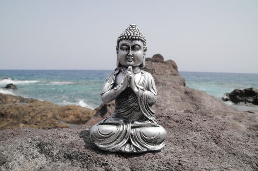 One Ancient Gray Buddha Statue Near The Ocean