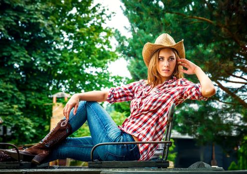 Sexy cowgirl. Young woman portrait in a hat