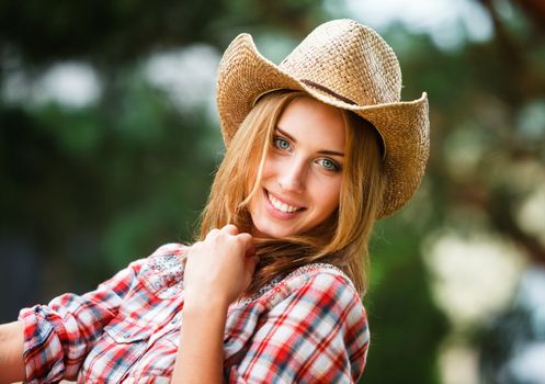 Sexy cowgirl. Young woman portrait in a hat