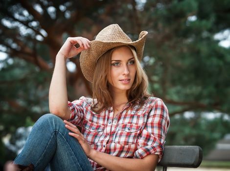 Sexy cowgirl. Young woman portrait in a hat